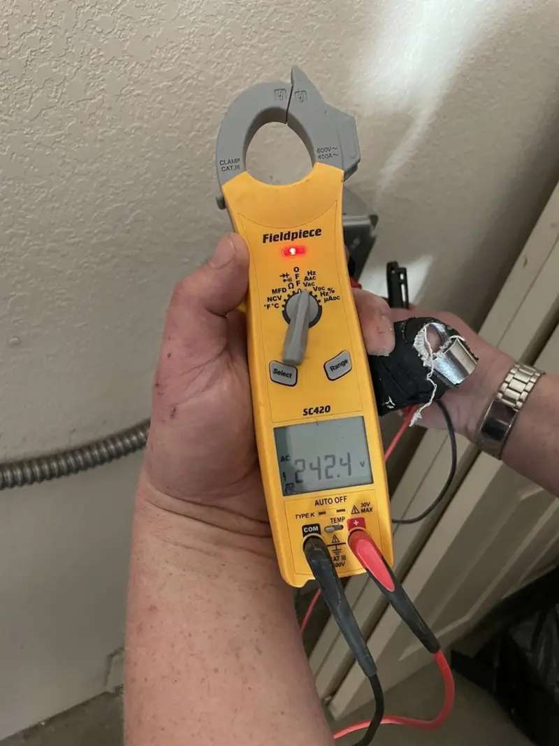 Voltage testing with clamp meter during Ceiling Fan Installation in Iona